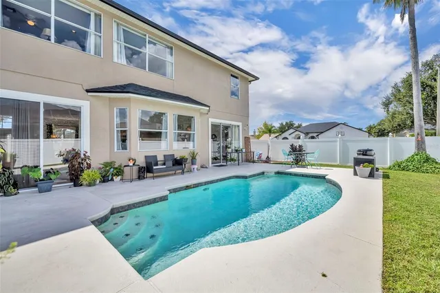 an aerial view of residential houses with outdoor space and trees