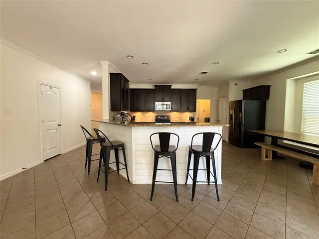 a bedroom with a bed and a ceiling fan