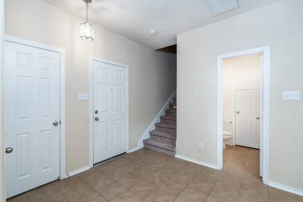 an empty room with windows and closet