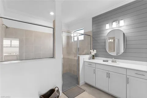a bathroom with a double vanity sink and a mirror