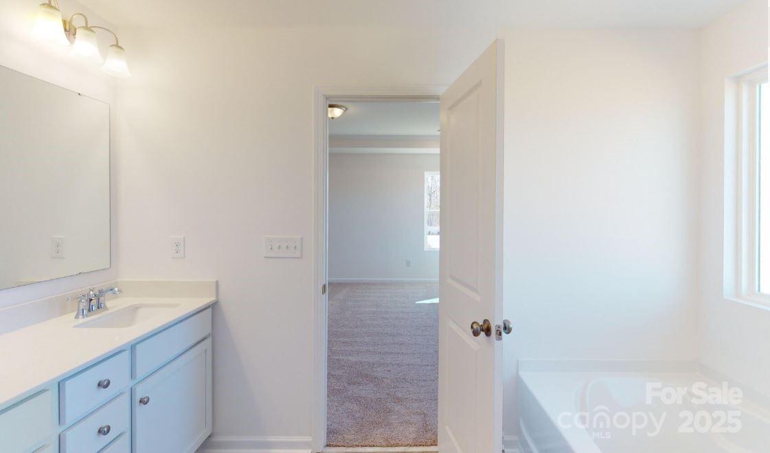1805 Augustine Street Monroe, NC 28112 - Photo 16 of 17 a bathroom with a granite countertop sink shower and a mirror