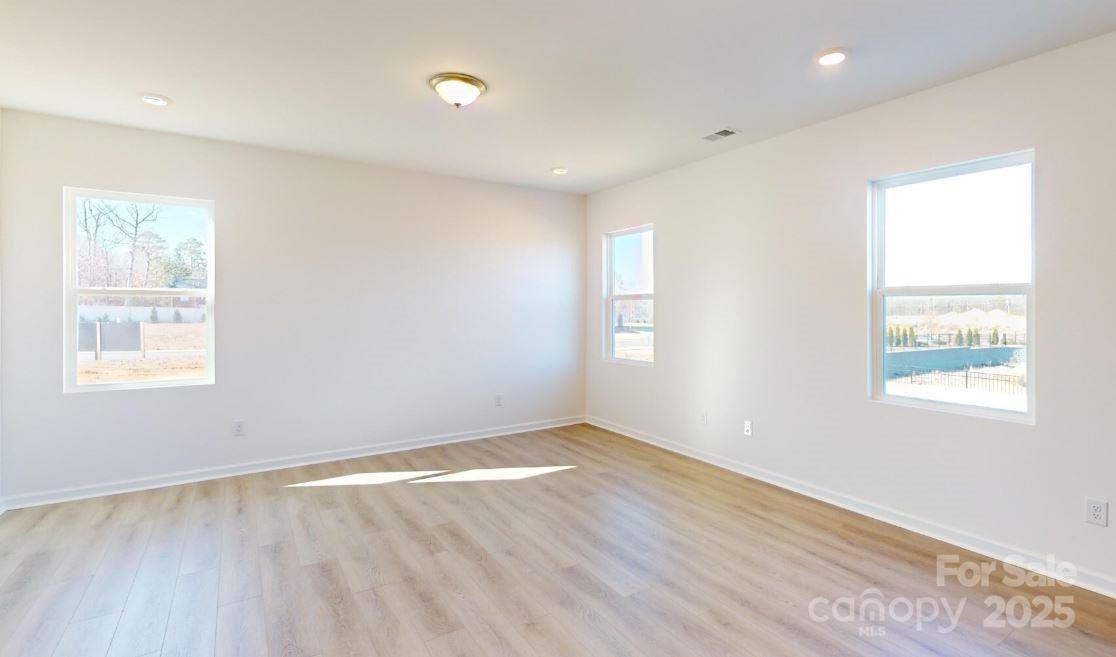 1805 Augustine Street Monroe, NC 28112 - Photo 5 of 17 a view of empty room with wooden floor and fan
