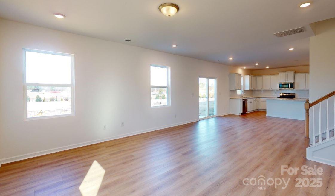 1805 Augustine Street Monroe, NC 28112 - Photo 6 of 17 a view of kitchen with window and wooden floor