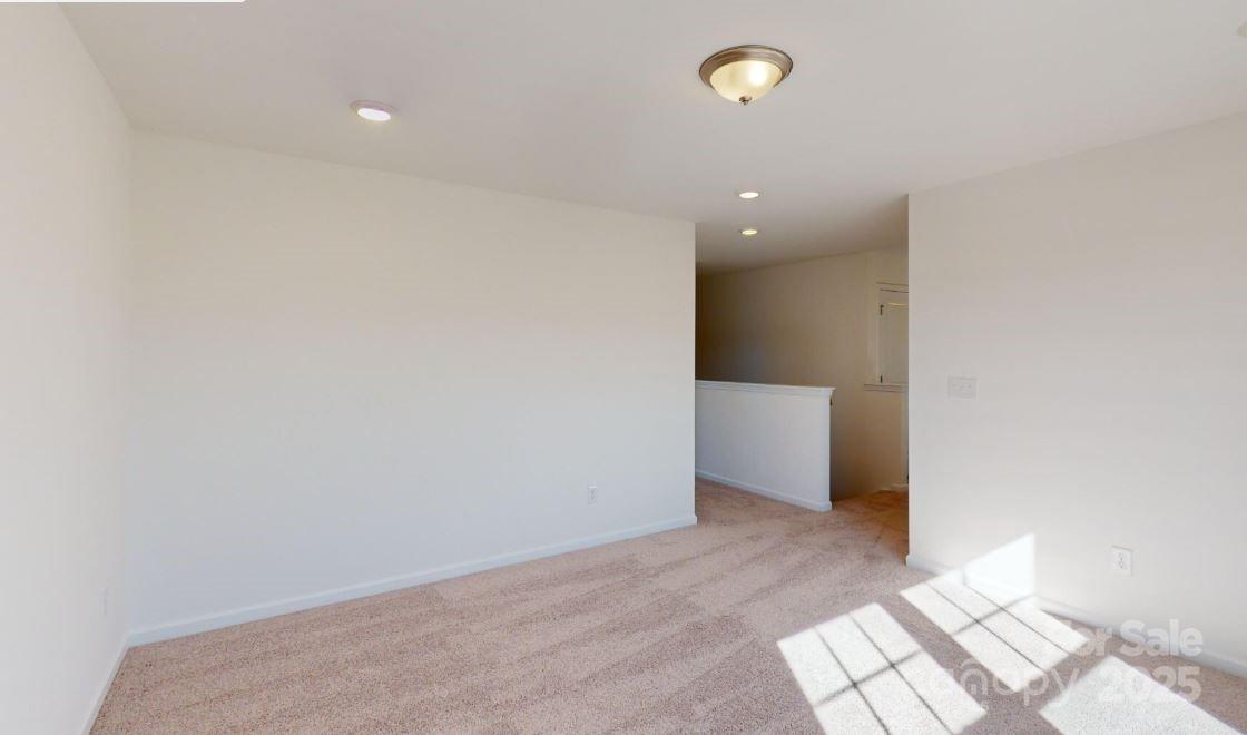 1805 Augustine Street Monroe, NC 28112 - Photo 10 of 17 an empty room with wooden floor and windows
