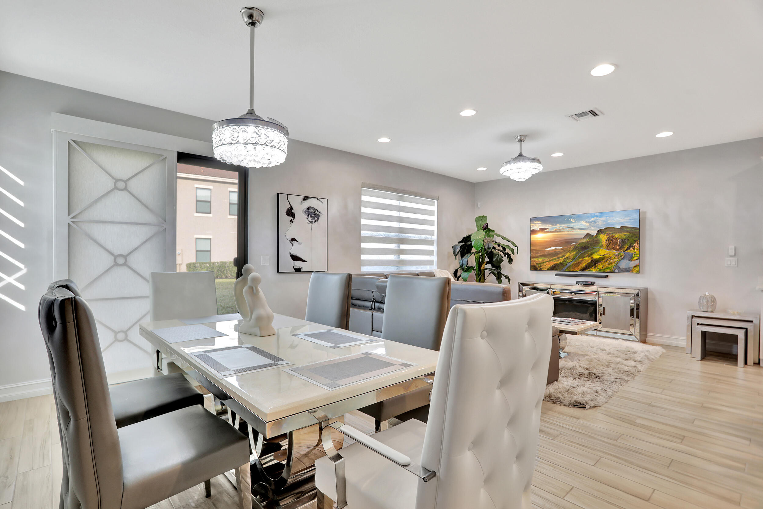 9517 Glider Way Boca Raton, FL 33428 - Photo 11 of 60 a view of a dining room with furniture wooden floor and chandelier