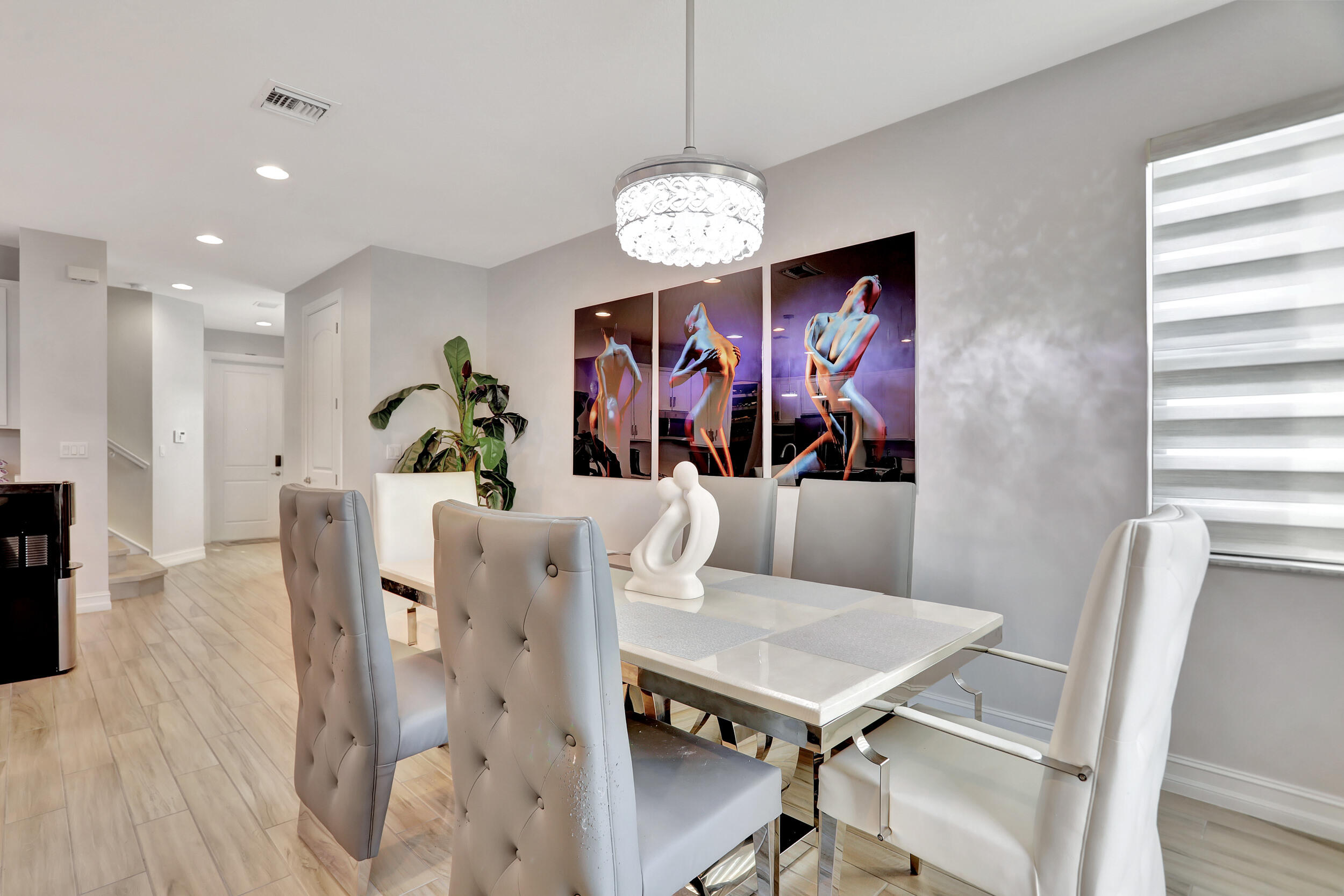 9517 Glider Way Boca Raton, FL 33428 - Photo 16 of 60 a view of a dining room with furniture wooden floor and a chandelier
