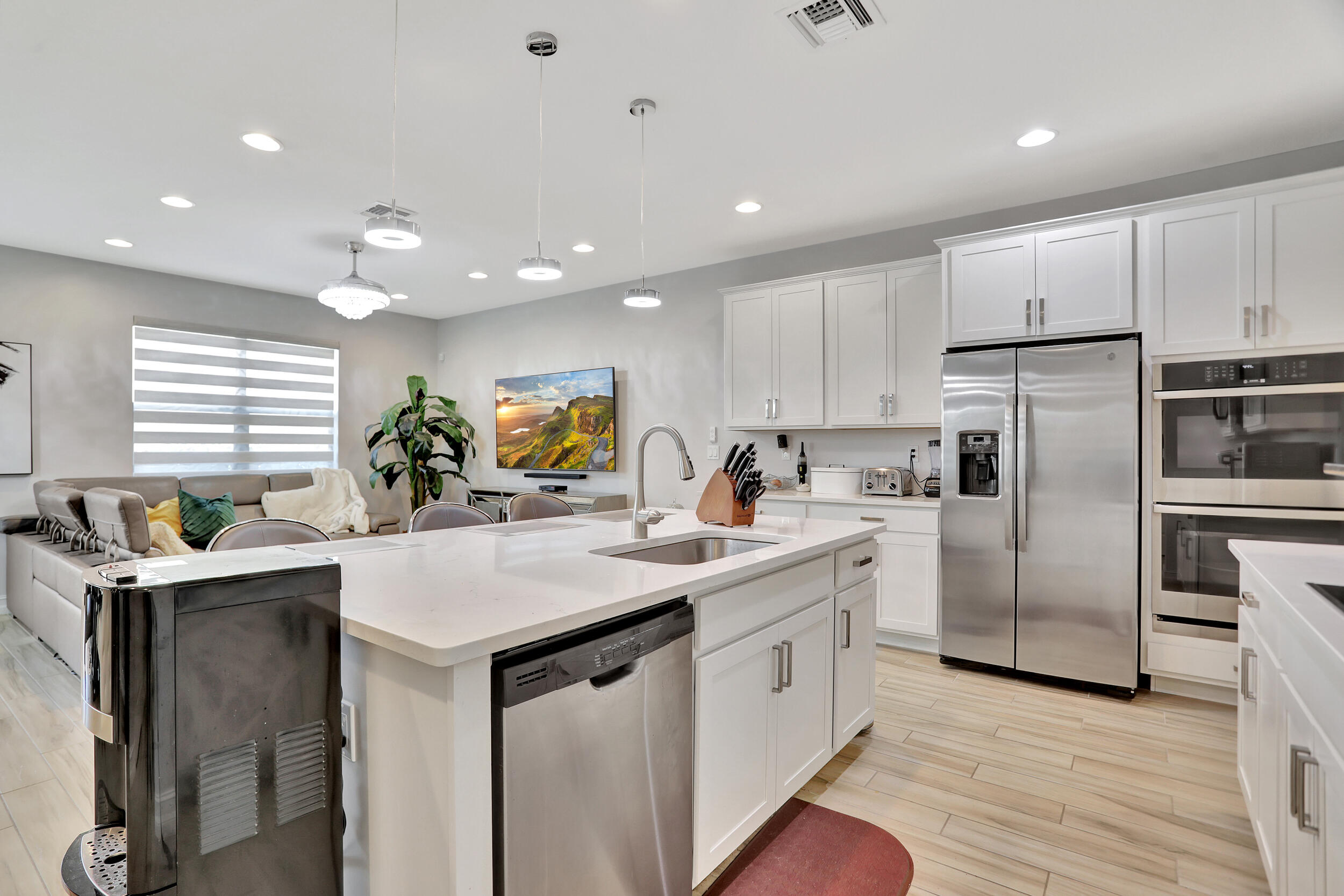 9517 Glider Way Boca Raton, FL 33428 - Photo 21 of 60 a kitchen with a sink stainless steel appliances and white cabinets