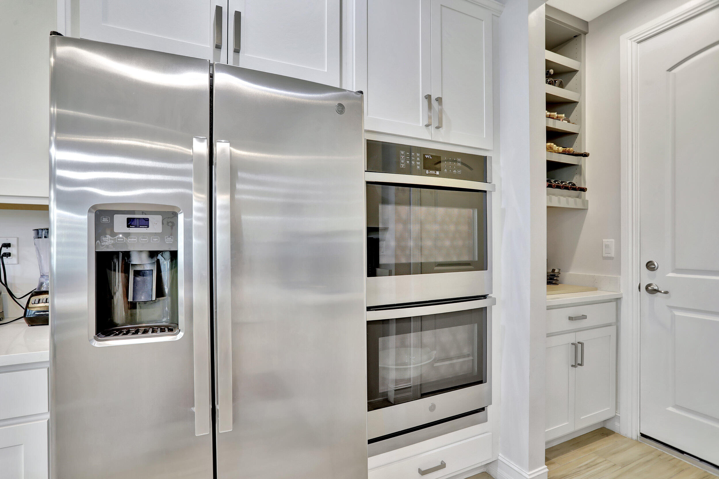 9517 Glider Way Boca Raton, FL 33428 - Photo 24 of 60 a kitchen with cabinets and stainless steel appliances