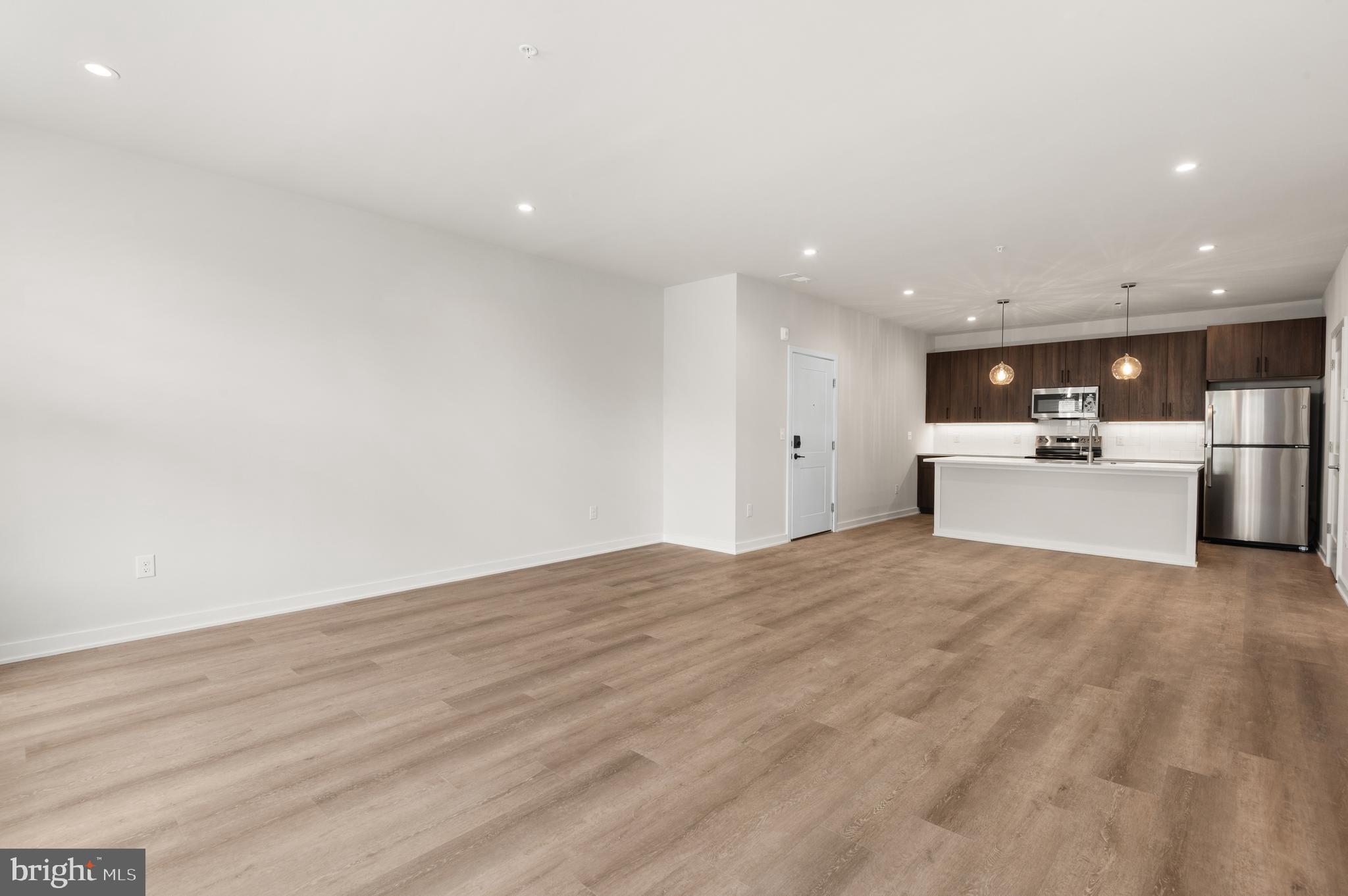 a view of a kitchen with a sink and a refrigerator