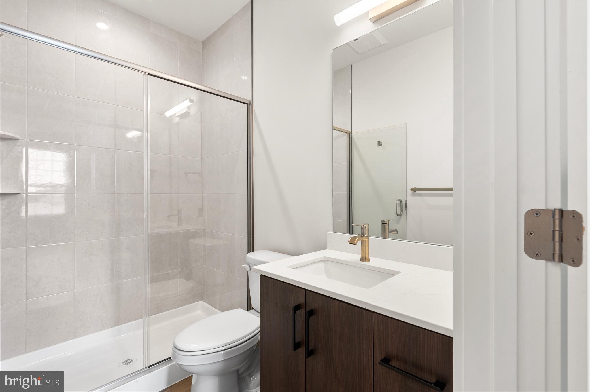 26 South York Road, Unit 401 Hatboro, PA 19040 - Photo 12 of 53 a bathroom with a sink a toilet and shower
