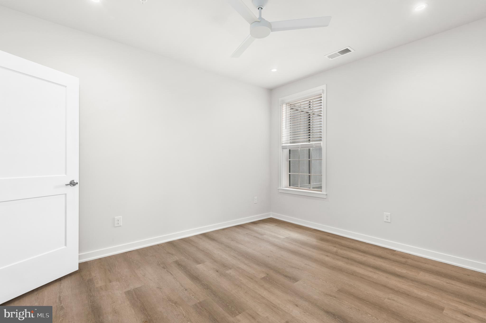 26 South York Road, Unit 401 Hatboro, PA 19040 - Photo 14 of 54 an empty room with wooden floor and windows