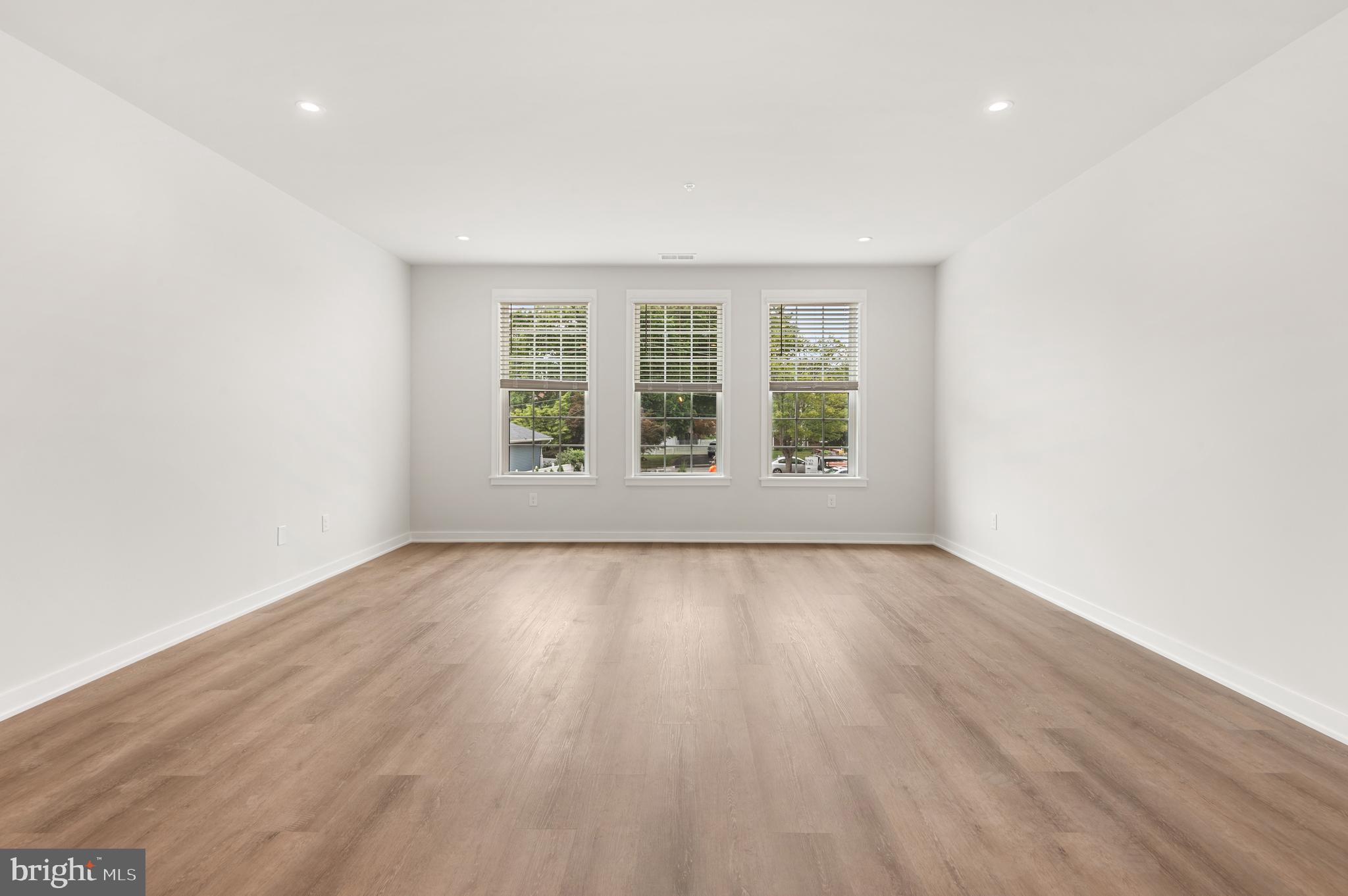 26 South York Road, Unit 401 Hatboro, PA 19040 - Photo 15 of 53 an empty room with wooden floor and windows