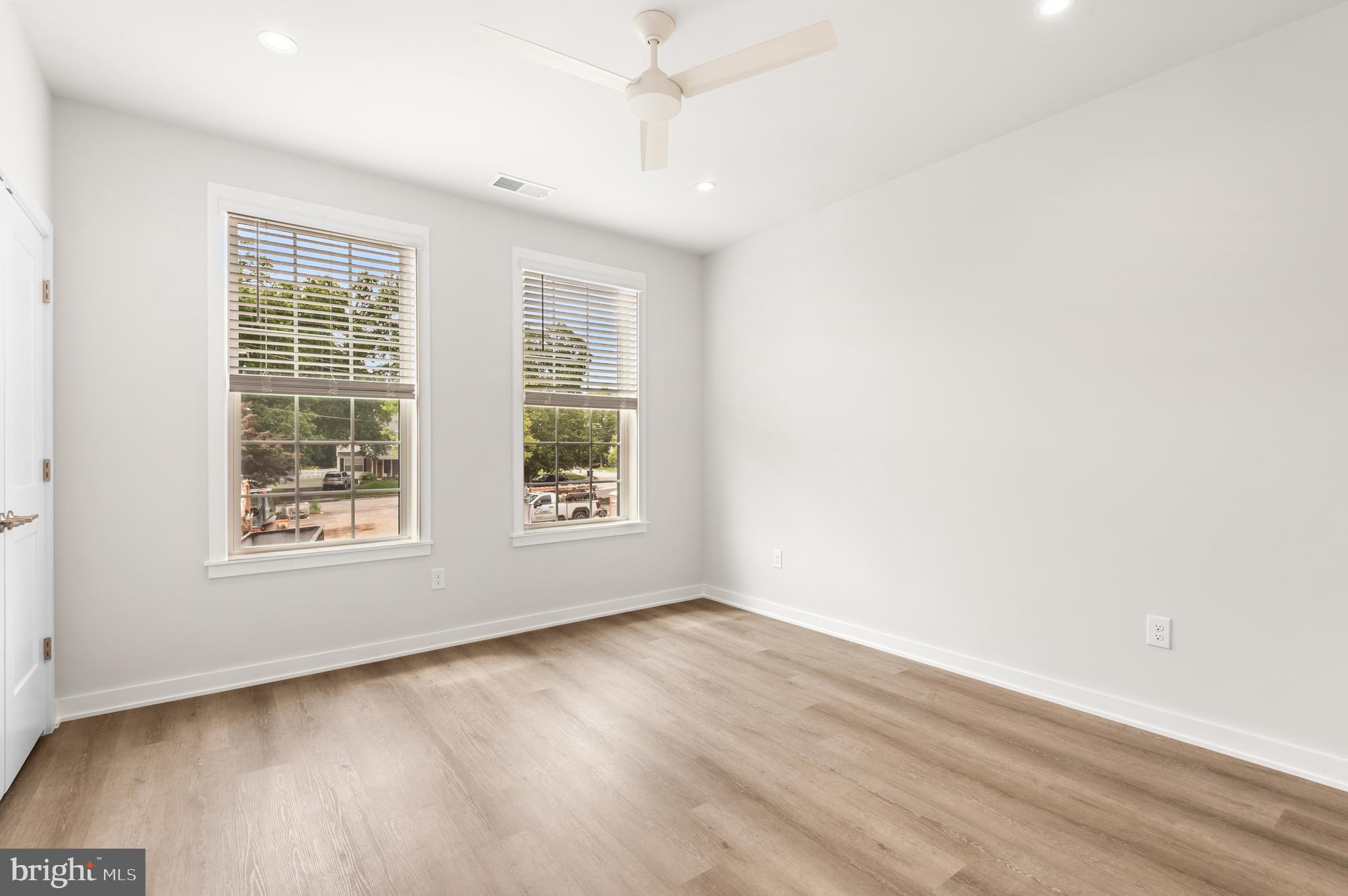 26 South York Road, Unit 401 Hatboro, PA 19040 - Photo 10 of 53 an empty room with wooden floor and windows