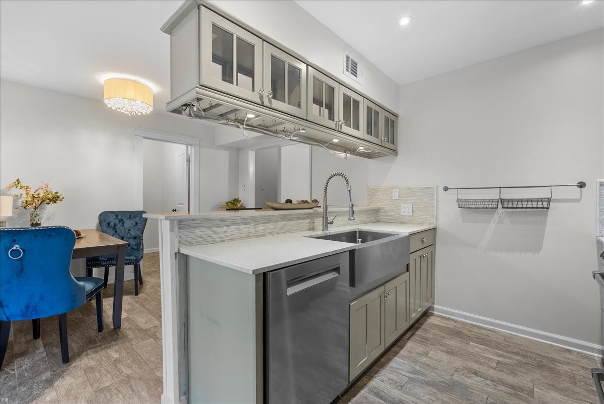 1572 Silverpines Road, Unit 572 Houston, TX 77062 - Photo 10 of 37 Undercabinet lighting brightens the workspace, while the large farmhouse sink and upgraded faucet add a gourmet flair to the kitchen.