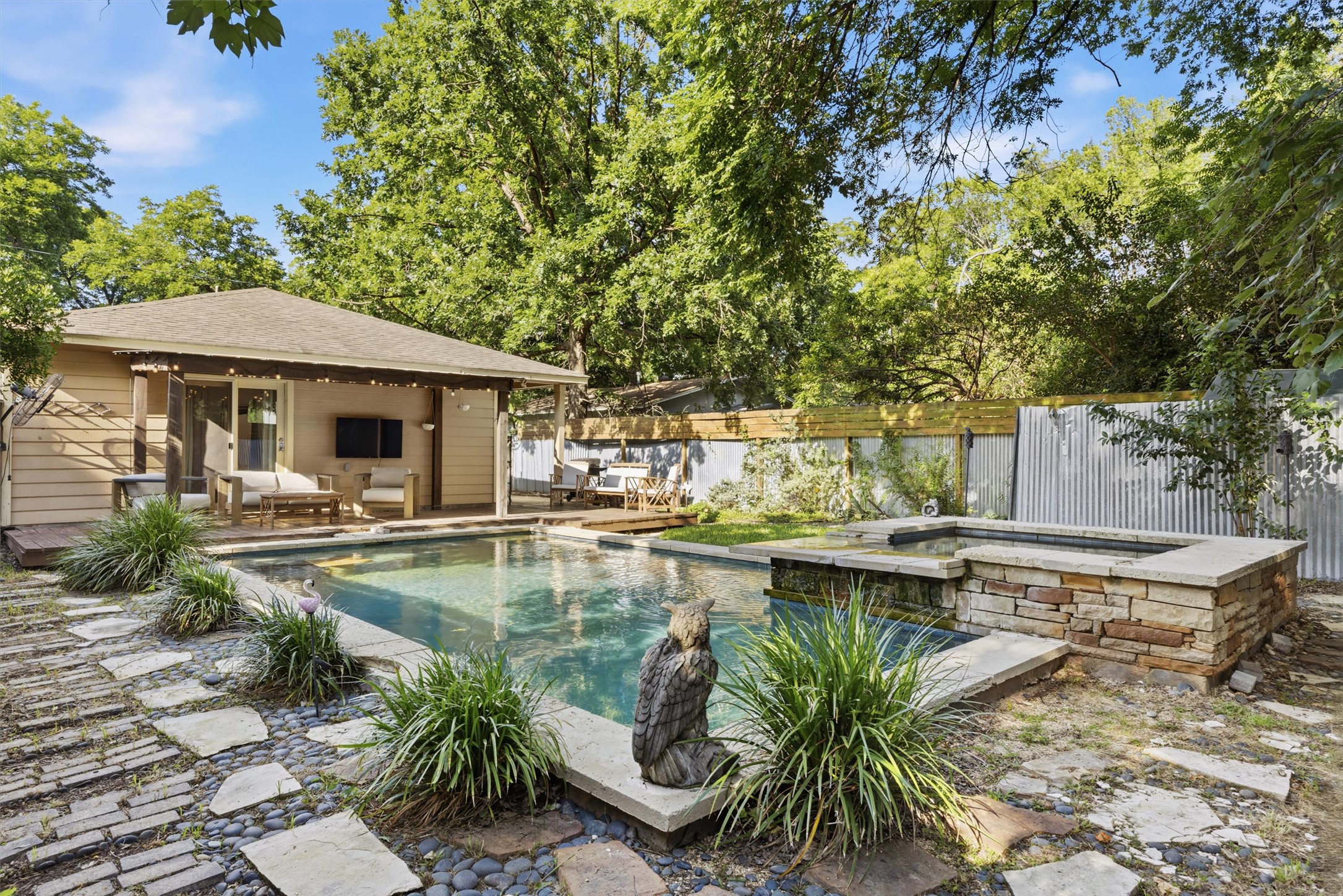 3015 Castro Street Austin, TX 78702 - Photo 38 of 40 An inviting backyard oasis offers a sparkling pool, adjacent spa, and comfortable covered patio.