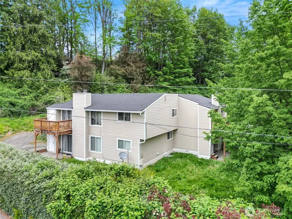 an aerial view of a house with a yard