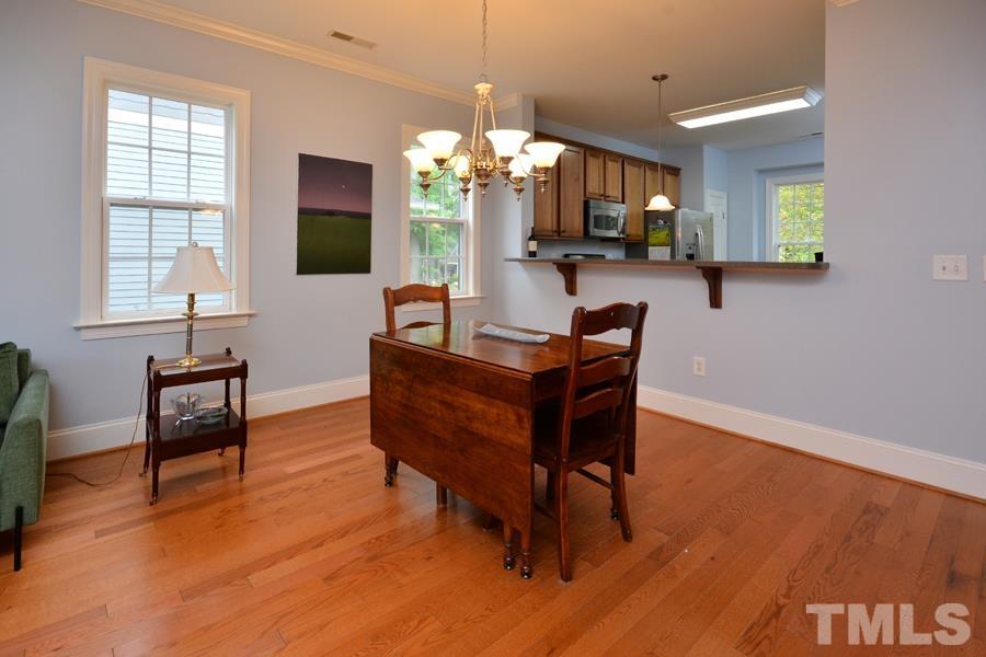 1524 North Duke Street Durham, NC 27701 - Photo 13 of 28 a living room with furniture a dining table and a chandelier