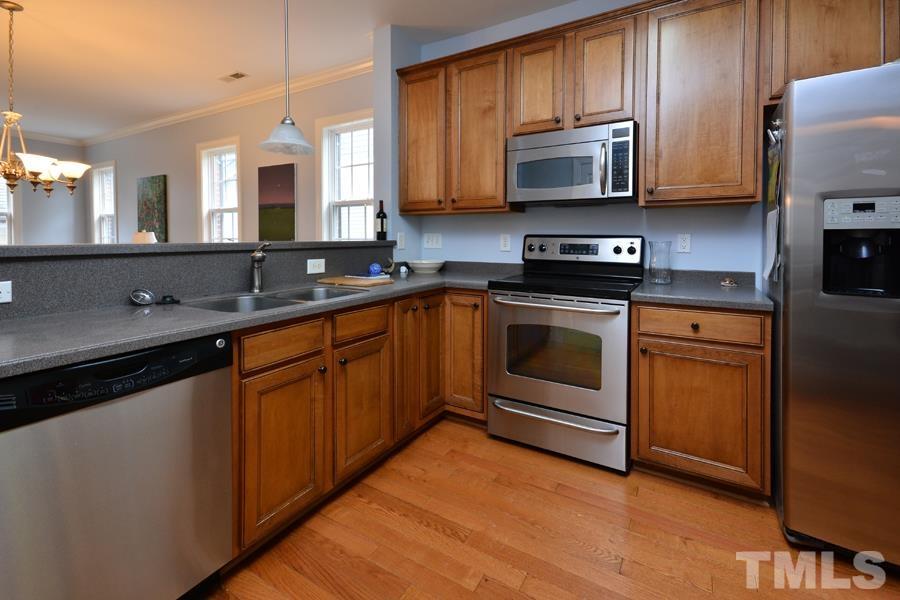 1524 North Duke Street Durham, NC 27701 - Photo 3 of 28 a kitchen with stainless steel appliances granite countertop wooden cabinets stove top oven and microwave