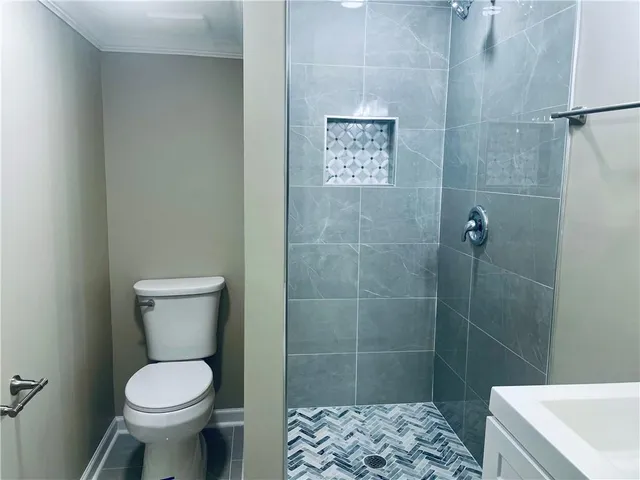 a bathroom with a toilet sink and shower
