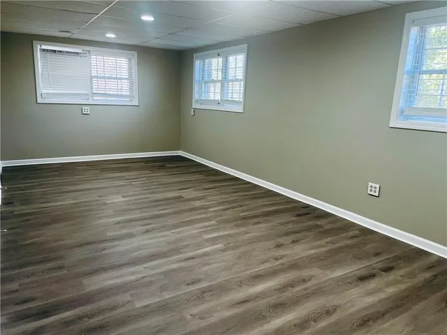 a view of a room with wooden floor and windows