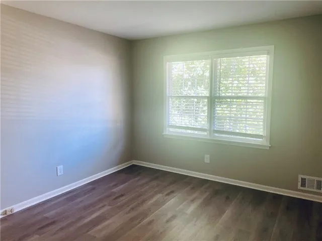 a view of a room with wooden floor and window