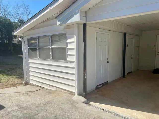 a view of a house with a door and a floor to ceiling window