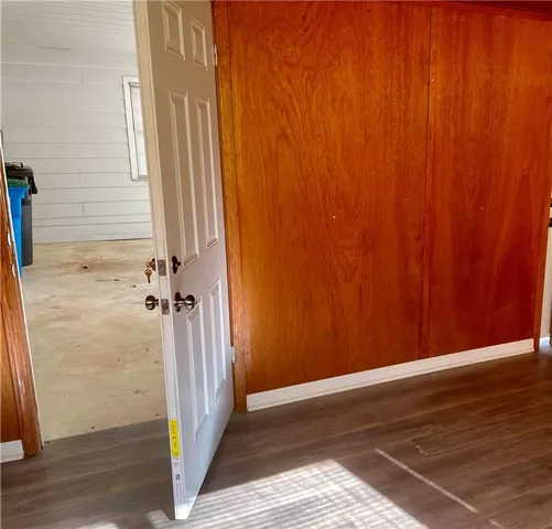 a view of a room with wooden floor and entryway