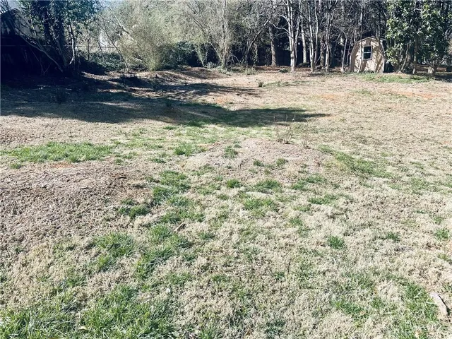 a view of a yard with trees