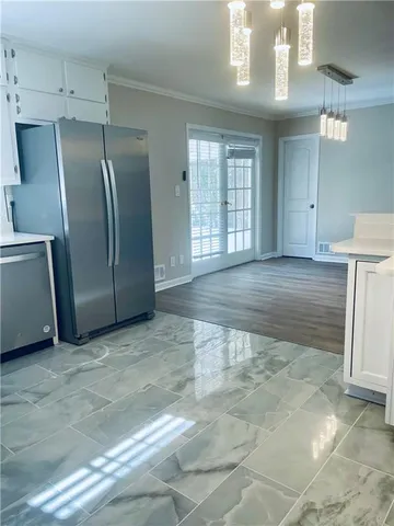 a view of an empty room with a kitchen
