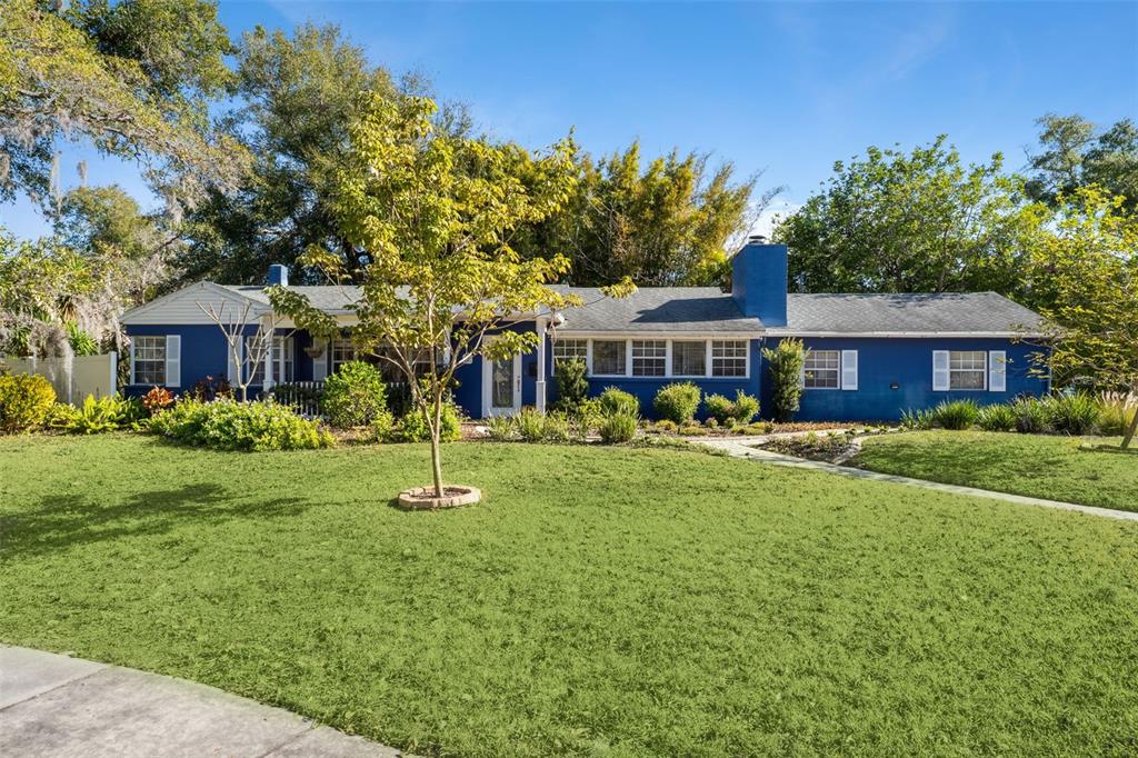 a front view of a house with a yard table and chairs