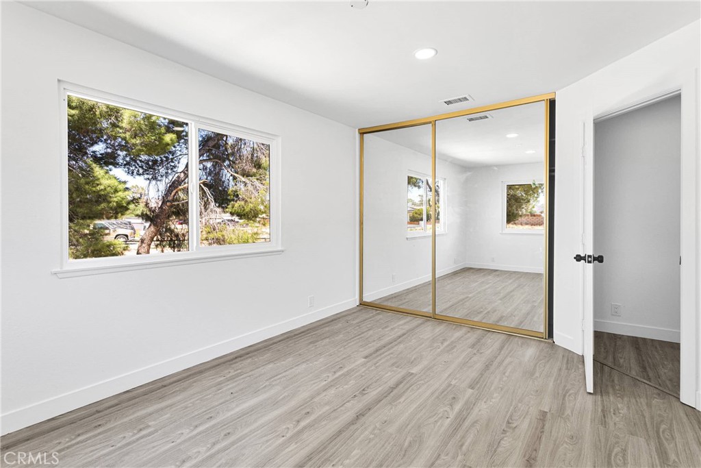 14855 Flathead Road Apple Valley, CA 92307 - Photo 11 of 14 wooden floor in an empty room with a window