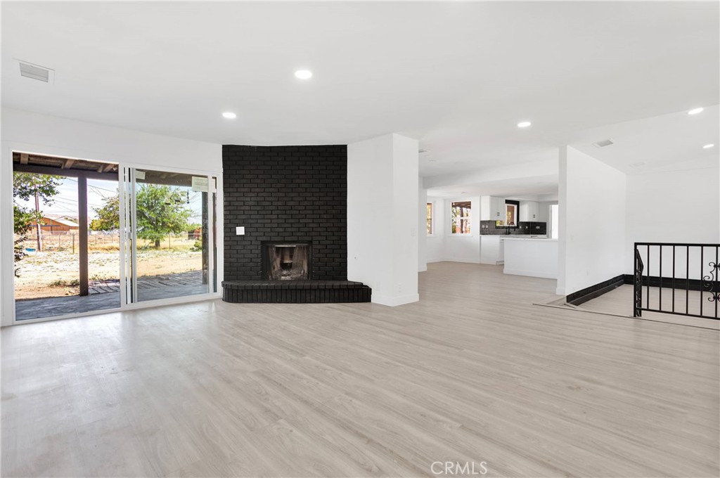 14855 Flathead Road Apple Valley, CA 92307 - Photo 4 of 14 a view of an empty room with wooden floor and a window