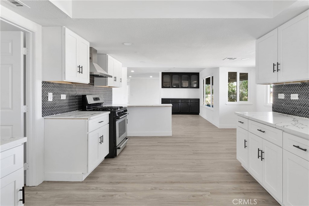 14855 Flathead Road Apple Valley, CA 92307 - Photo 6 of 14 a large kitchen with stainless steel appliances granite countertop a stove top oven a sink dishwasher and a refrigerator