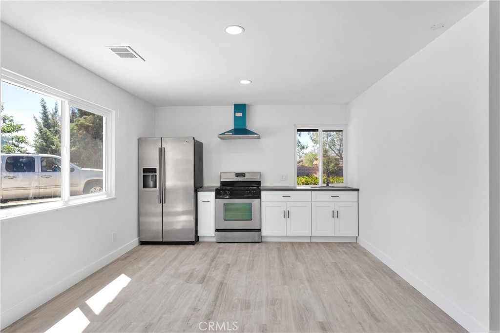 14855 Flathead Road Apple Valley, CA 92307 - Photo 8 of 14 a kitchen with a refrigerator and windows