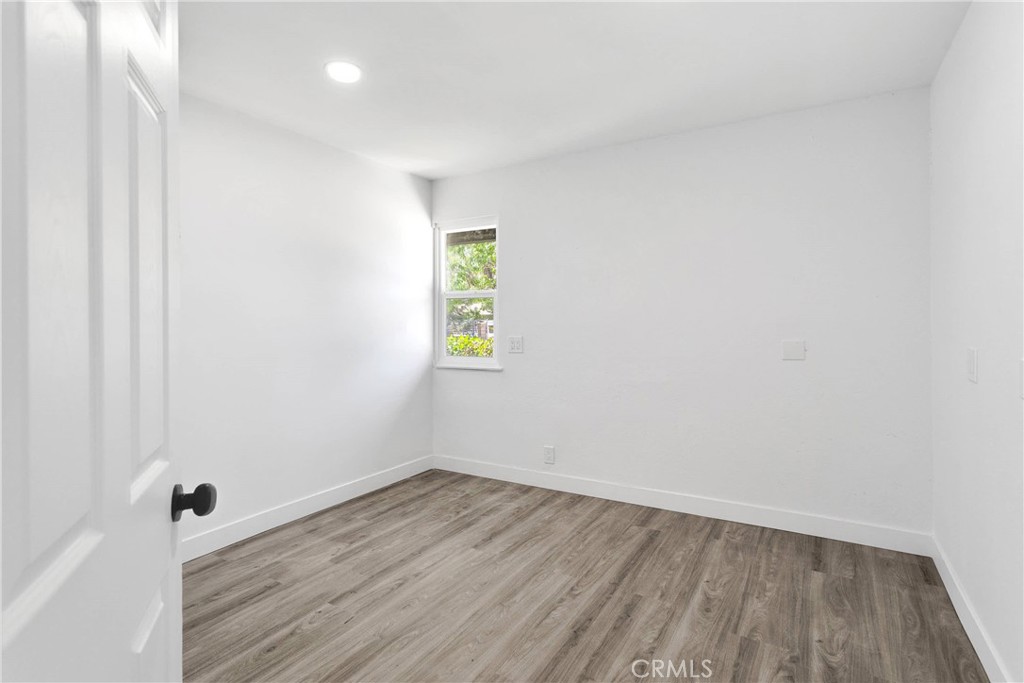 14855 Flathead Road Apple Valley, CA 92307 - Photo 9 of 14 a view of room with wooden floor and window