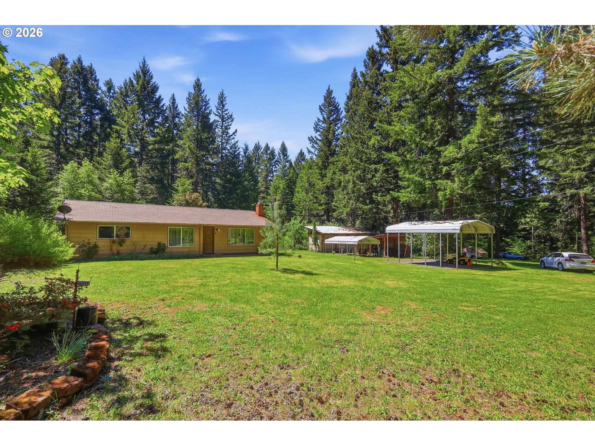 49782 Huckleberry Road Oakridge, OR 97463 - Photo 4 of 21 a view of a house with a yard