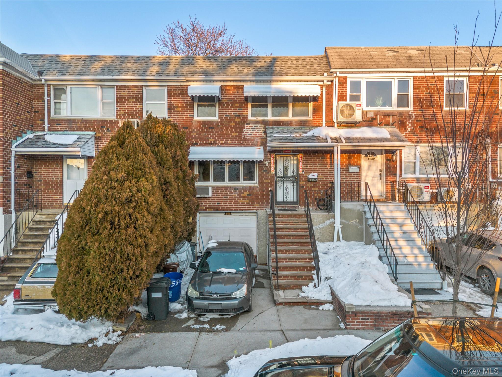 5-37 117th Street Queens, NY 11356 - Photo 1 of 28 a front view of a residential apartment building with a yard