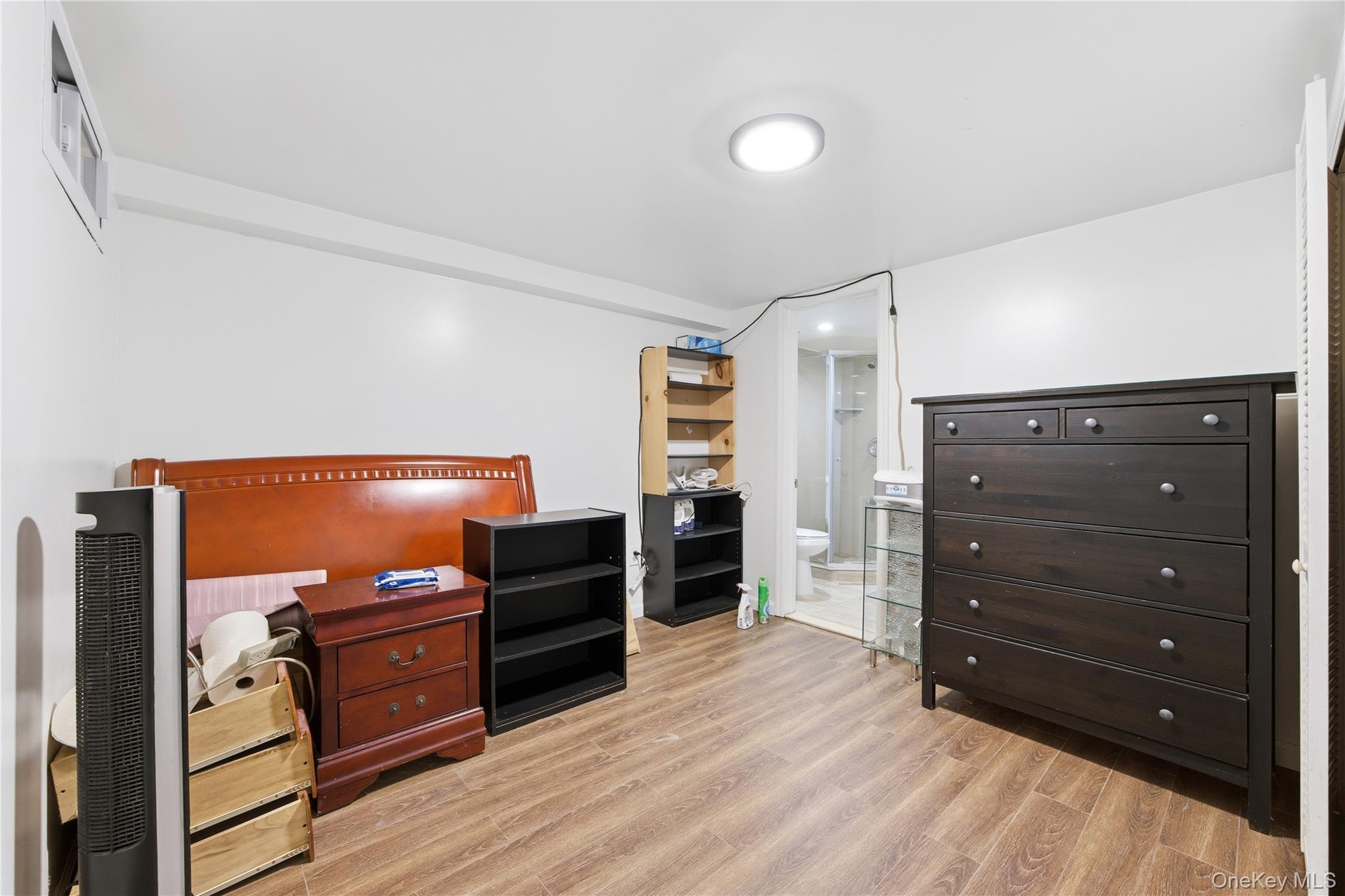 5-37 117th Street Queens, NY 11356 - Photo 14 of 28 a room with furniture and wooden floor