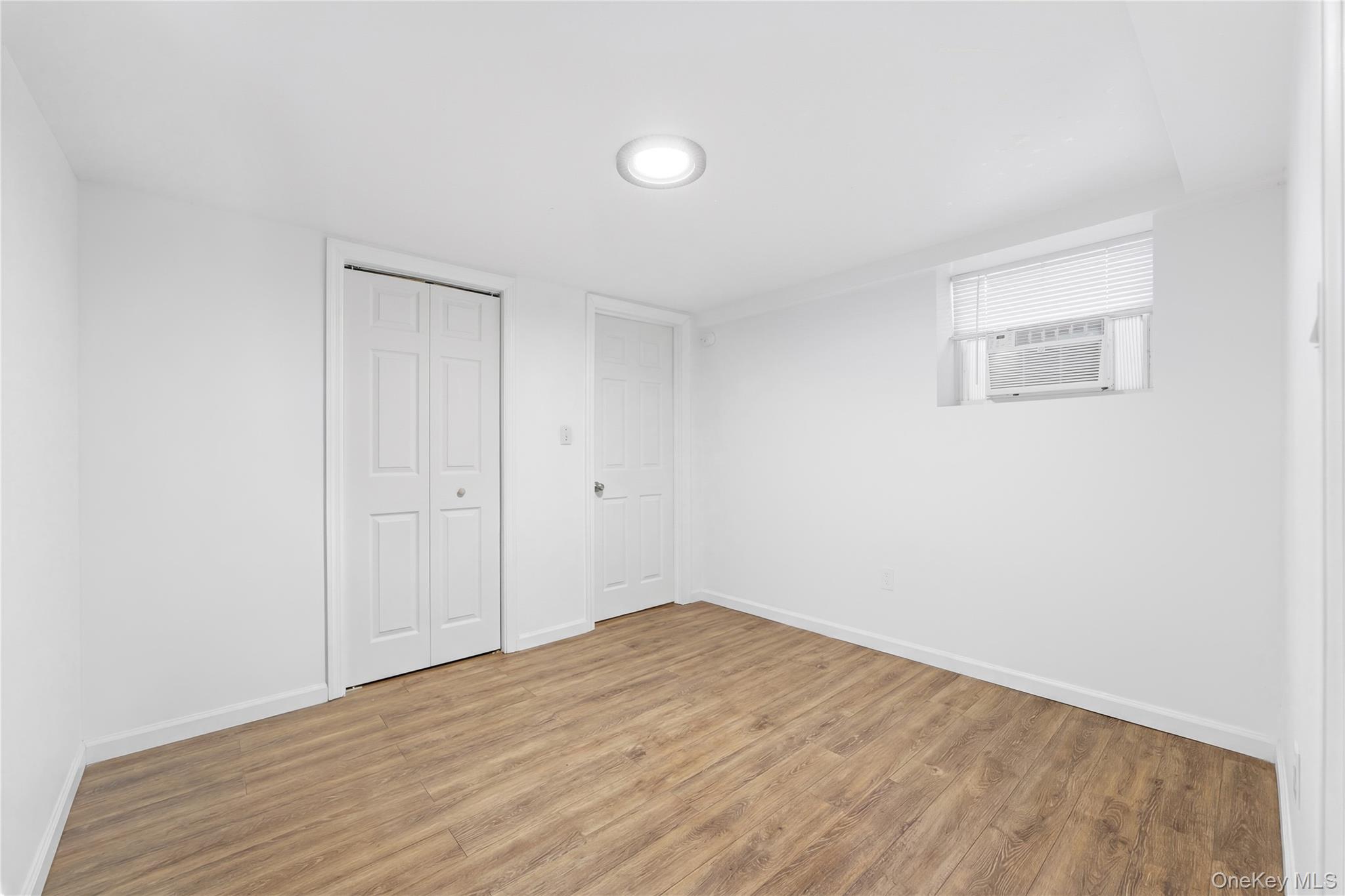 5-37 117th Street Queens, NY 11356 - Photo 15 of 28 a view of empty room with wooden floor
