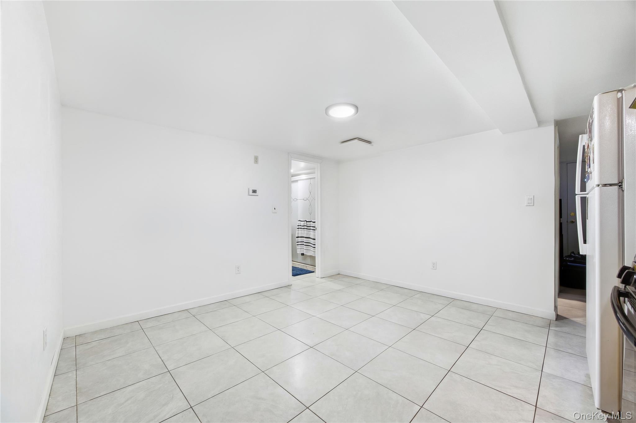 5-37 117th Street Queens, NY 11356 - Photo 16 of 28 an empty room with a fireplace