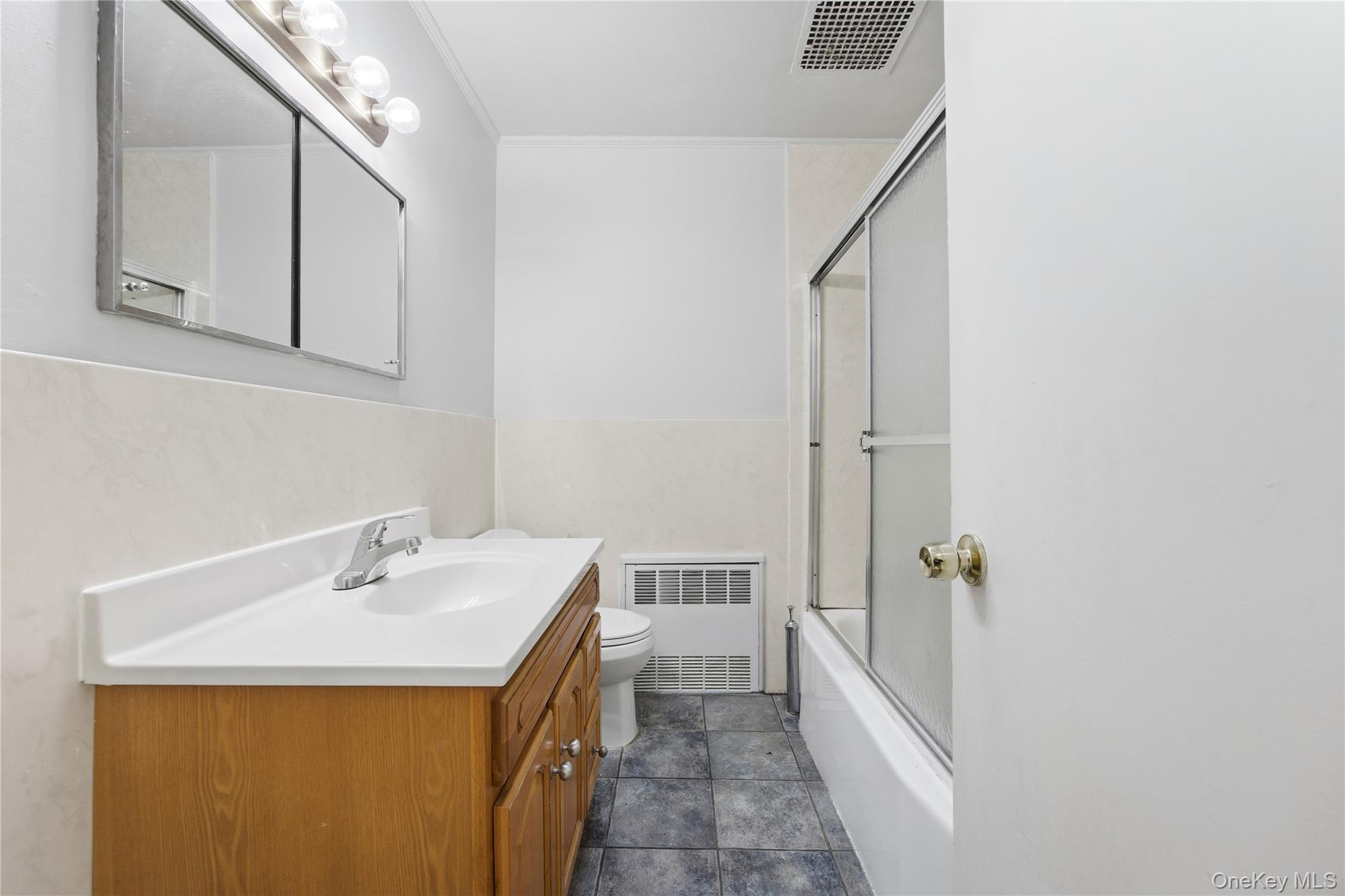 5-37 117th Street Queens, NY 11356 - Photo 18 of 28 a bathroom with a sink a toilet and shower