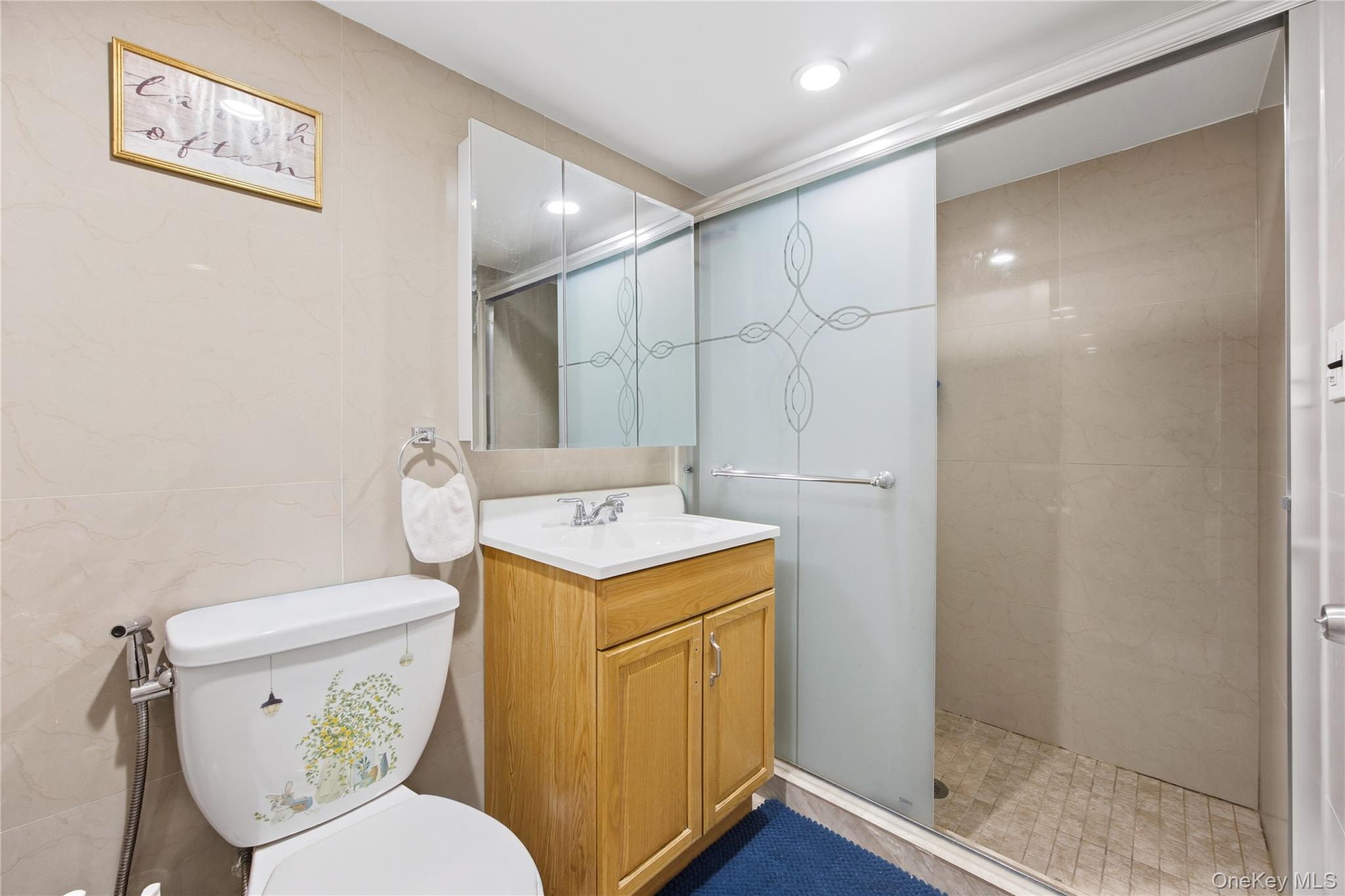 5-37 117th Street Queens, NY 11356 - Photo 19 of 28 a bathroom with a granite countertop toilet sink and shower