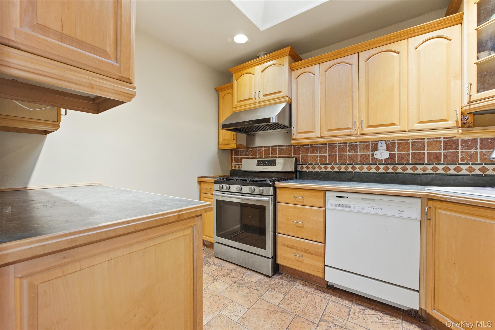 5-37 117th Street Queens, NY 11356 - Photo 3 of 28 a kitchen with stainless steel appliances granite countertop a stove a sink and a microwave