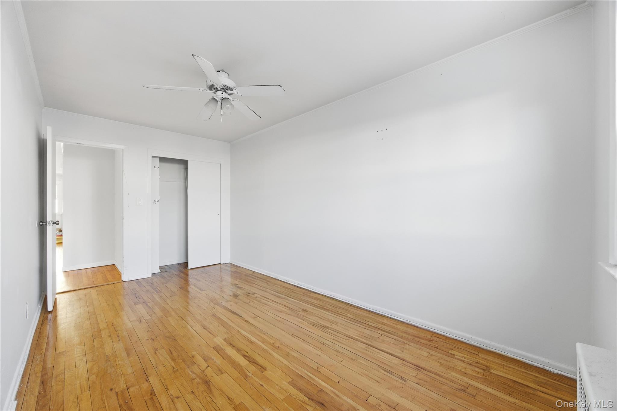 5-37 117th Street Queens, NY 11356 - Photo 10 of 28 a view of an empty room with wooden floor