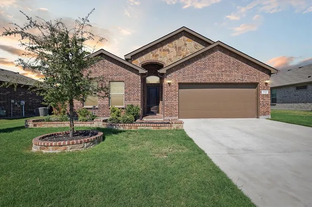 a front view of a house with a yard garage and outdoor seating