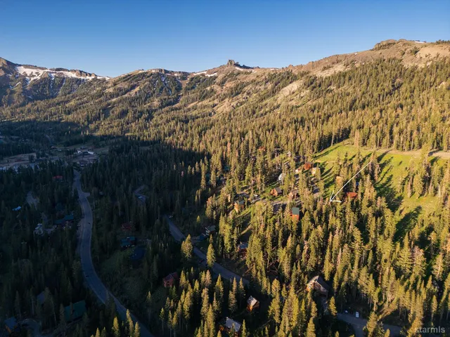 a view of a lush green hillside and houses