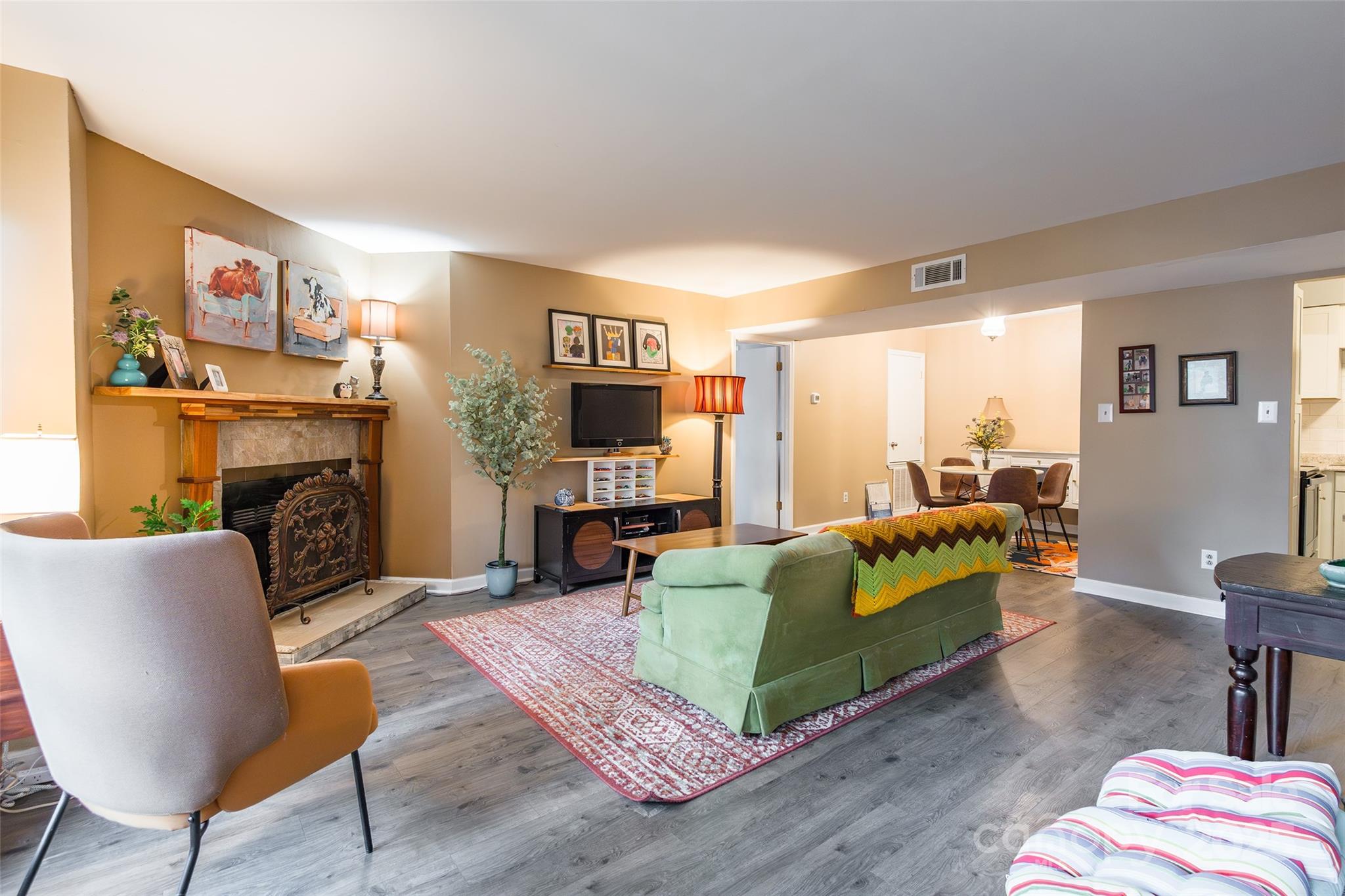 a living room with furniture a fireplace and a flat screen tv