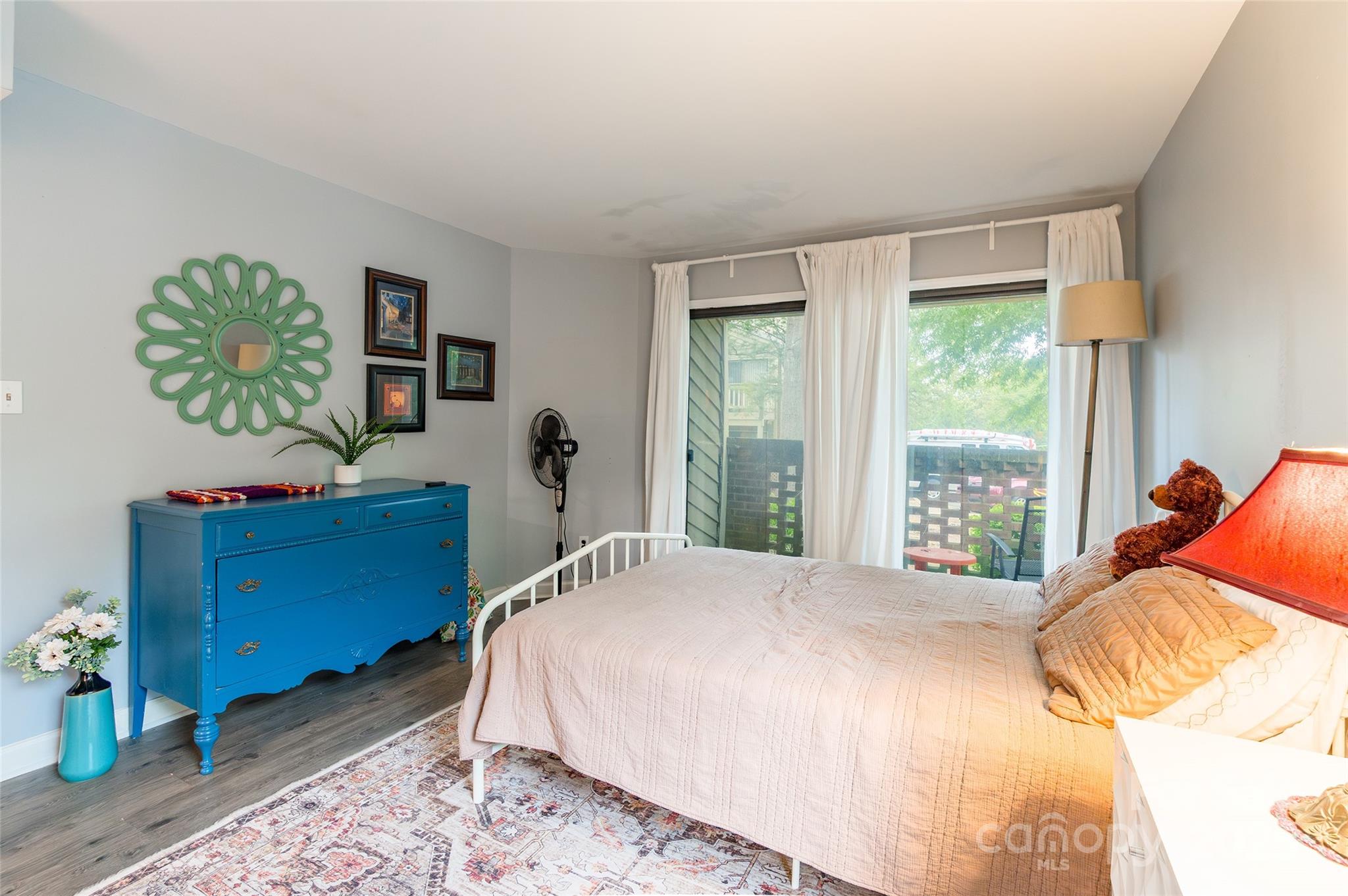 1604 Sharon Road West, Unit 23 Charlotte, NC 28210 - Photo 15 of 21 a bedroom with a bed table closet and a window