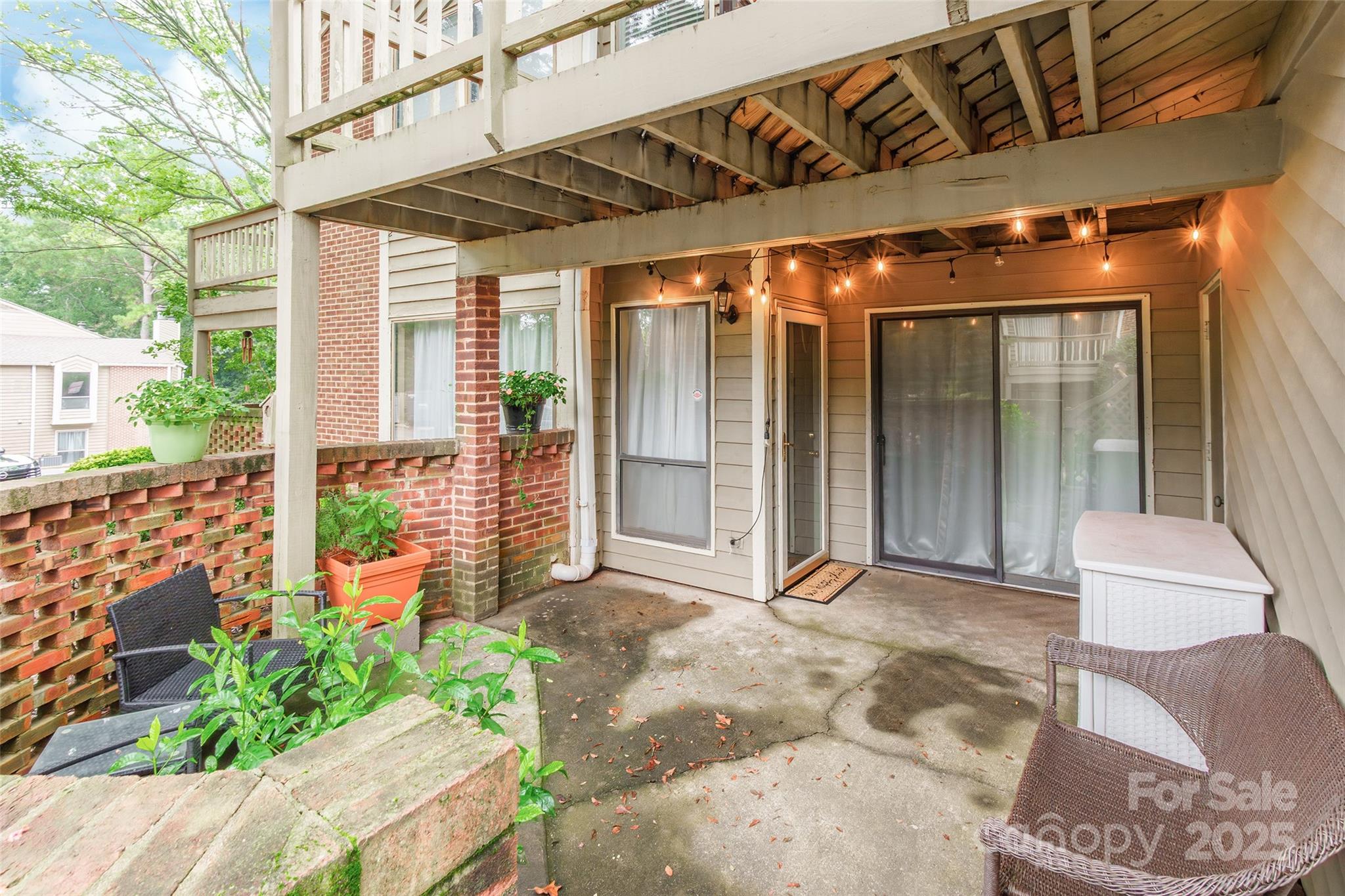 1604 Sharon Road West, Unit 23 Charlotte, NC 28210 - Photo 3 of 21 a view of a porch with furniture and floor to ceiling window