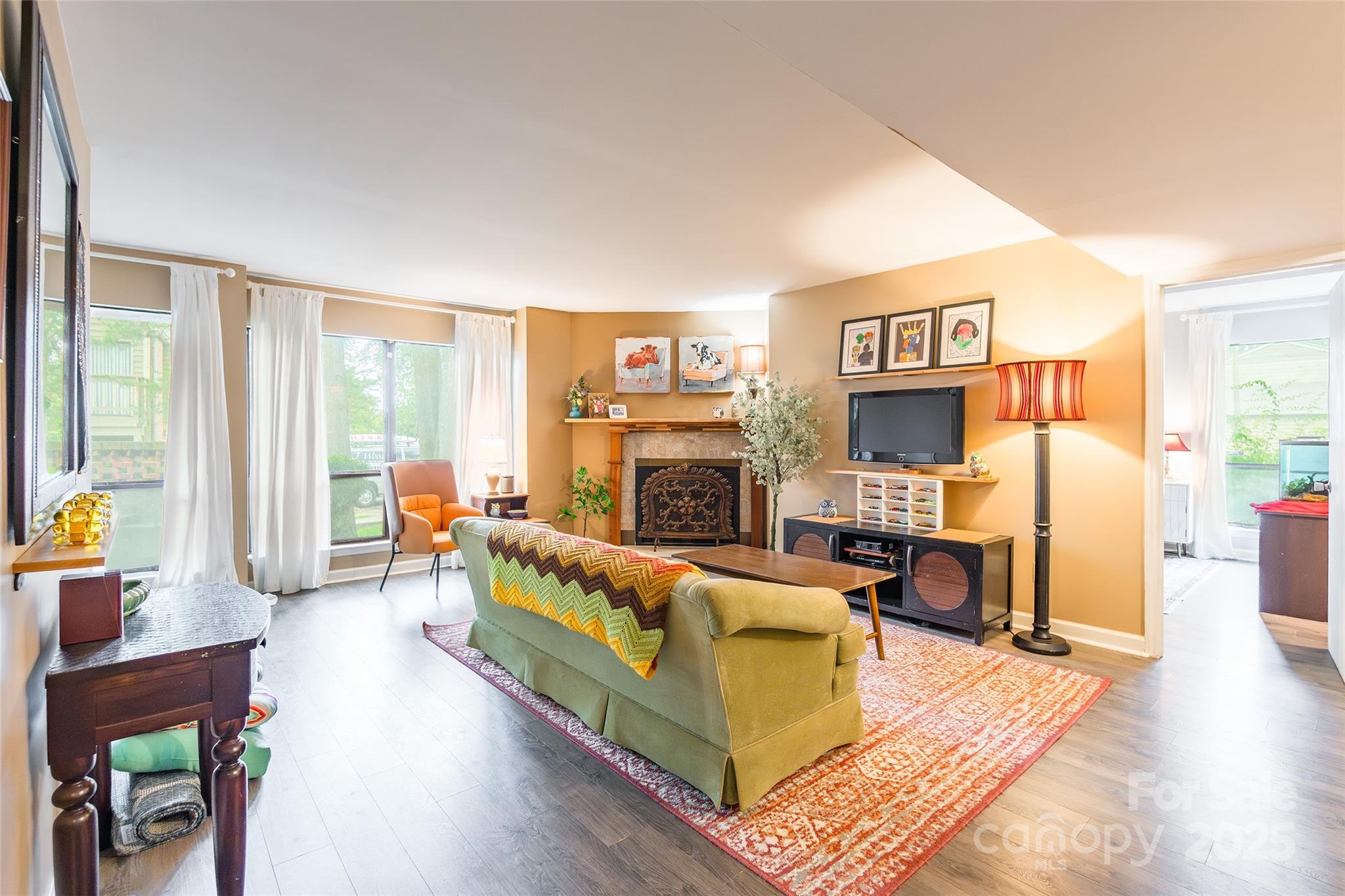 1604 Sharon Road West, Unit 23 Charlotte, NC 28210 - Photo 8 of 21 a living room with furniture large window and a fireplace